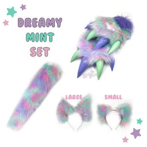 May include: A set of pastel-coloured faux fur accessories, including a tail, a pair of large ears, and a pair of small ears. The set is called "Dreamy Mint Set".