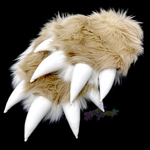 May include: A pair of brown and white furry slippers with white claws. The slippers are made of soft, plush fabric and have a realistic claw design.