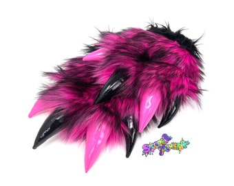 May include: A pair of pink and black faux fur claws with black patent leather accents. The claws are soft and fluffy and would be perfect for a costume or cosplay.