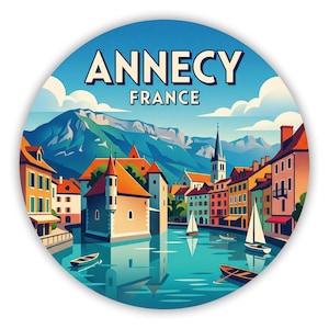 May include: A circular sticker featuring a colourful illustration of Annecy, France. The scene depicts a canal with sailboats and rowboats, surrounded by multi-coloured buildings, a church spire, and large mountains under a blue sky with clouds.