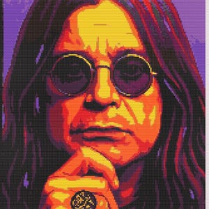 May include: A cross-stitch pattern featuring a portrait of a person with long hair wearing round glasses. The image uses a vibrant color palette of purple, orange, yellow, and red tones. A hand is positioned near the chin, displaying a dark ring.