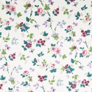 May include: White floral wallpaper with a repeating pattern of pink, purple, and green flowers on a white background.