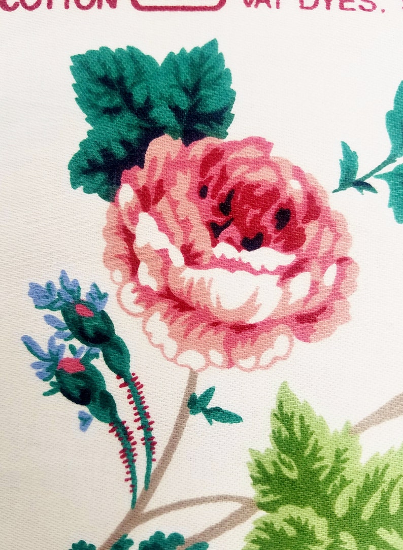 May include: A pink rose with green leaves and a stem with red and green details. The background is white.