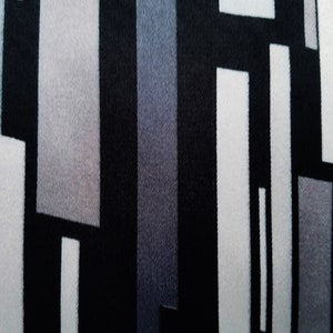 May include: Abstract geometric pattern fabric with black, white, and gray stripes and rectangles.