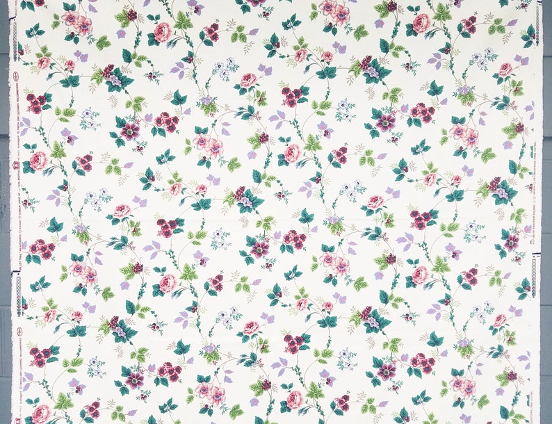 May include: White floral wallpaper with a repeating pattern of pink, purple, and green flowers on a white background.