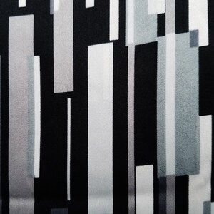May include: Abstract geometric pattern fabric with vertical stripes in black, white, and gray.