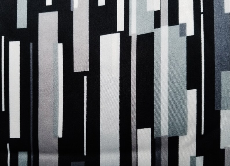 May include: Abstract geometric pattern fabric with vertical stripes in black, white, and gray.