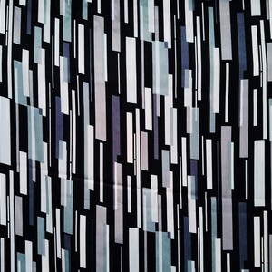 May include: Abstract geometric pattern fabric with vertical stripes in shades of gray, white, and black on a black background.