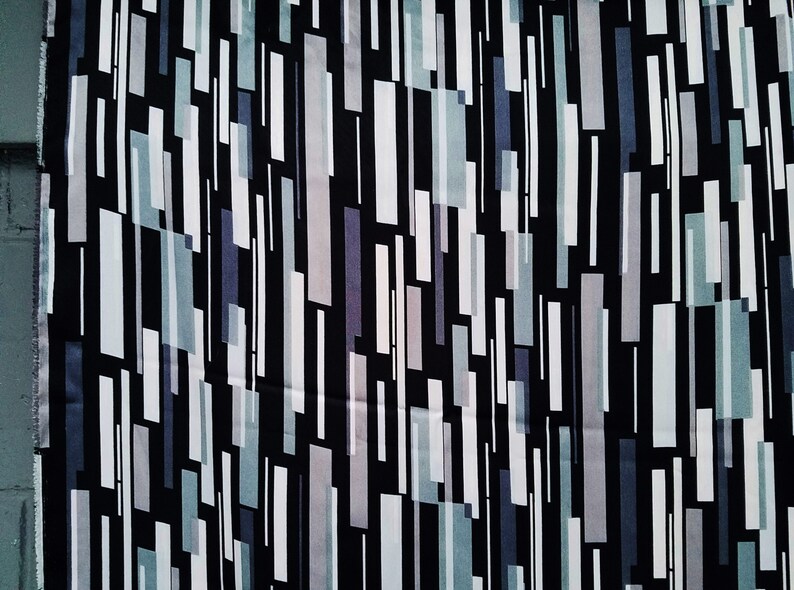 May include: Abstract geometric pattern fabric with vertical stripes in shades of gray, white, and black on a black background.