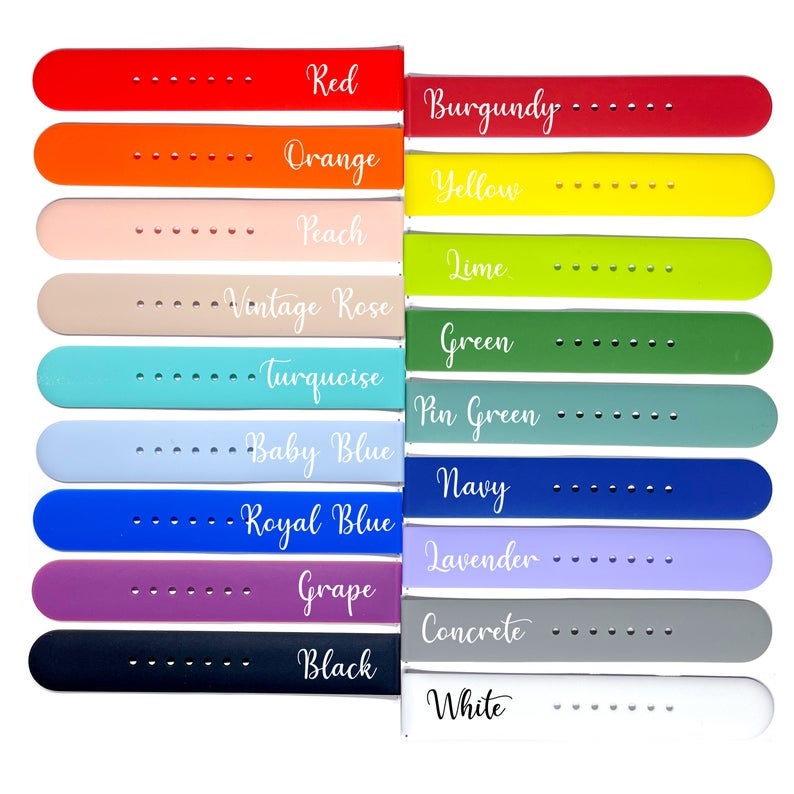 May include: A set of 14 silicone watch bands in various colors, including red, orange, peach, vintage rose, turquoise, baby blue, royal blue, grape, black, burgundy, yellow, lime, pin green, navy, lavender, concrete, and white. Each band has the color name printed on it.