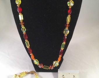 Handmade 3 pc necklace bracelet and earrings set in red orange and yellow.