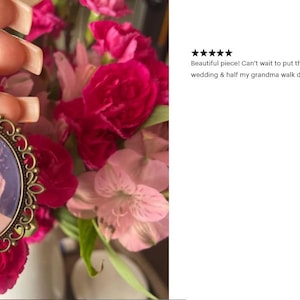 a hand holding a picture of a woman