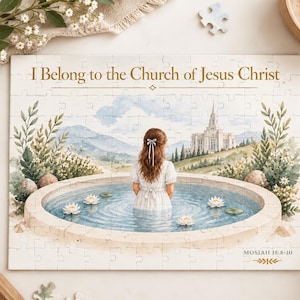May include: A rectangular jigsaw puzzle featuring a watercolor illustration of a person standing in a circular stone pool with water lilies. The text reads I Belong to the Church of Jesus Christ at the top and MOSIAH 18:8-10 at the bottom right.