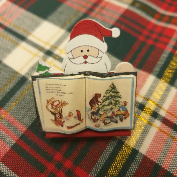 Dollhouse miniature wooden Christmas book holder and an open book that tells Christmas stories