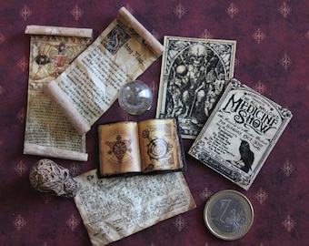May include: A collection of vintage-style miniature items, including scrolls, a book, a crystal ball, a skull, a poster for a medicine show, and a coin. The items are arranged on a burgundy background with a repeating pattern.