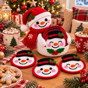 May include: A set of crocheted snowman coasters with a matching snowman-shaped holder. Each coaster features a white face, orange nose, black hat, and red trim. The holder is topped with a crocheted snowman wearing a red hat and scarf.