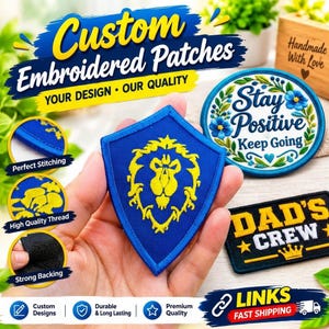 May include: Custom embroidered patches featuring a blue shield with a yellow lion emblem, a round patch with blue flowers and the text Stay Positive Keep Going, and a rectangular black patch with the yellow text DAD'S CREW and a crown icon.