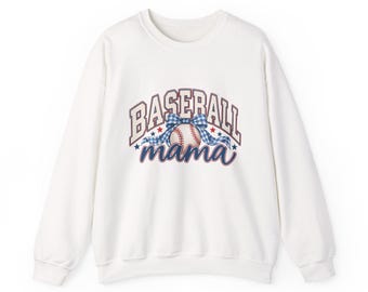 May include: A white long-sleeve sweatshirt featuring a graphic print with the text BASEBALL in a collegiate font and mama in a script font. The design includes a baseball with a blue and white gingham bow, accented by small red and blue stars.