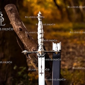 May include: A silver-toned metal dagger featuring a twisted handle, a cross-shaped guard, and a blade with a cross-shaped cutout. The dagger is accompanied by a black scabbard with a silver-toned metal tip. The text BLADESLORDCO appears repeatedly.