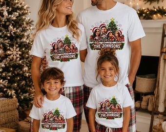 May include: White short-sleeve t-shirts featuring a custom graphic of a family wearing Santa hats in front of a Christmas tree, with the text THE JOHNSONS printed below. The shirts are paired with red, green, and white plaid pajama pants.