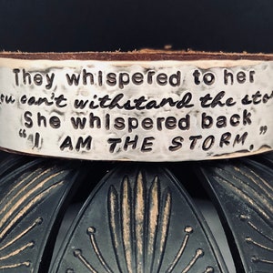 They whispered to her “you can’t withstand the storm”. She whispered back “I am the storm”.  hand stamped leather cuff bracelet ~ mantra