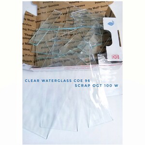 May include: A box of clear waterglass scrap, labeled "CLEAR WATERGLASS COE 96 SCRAP OGT 100 W".