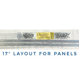 May include: Two silver metal strips, each 17 inches long, with small holes along the edges. A package of silver metal pins is included. The package label reads "Mosaic Glass Works Layout Blocks".