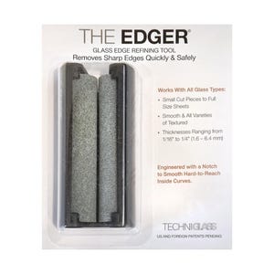 May include: The Edger glass edge refining tool in black packaging. The tool features two grey abrasive stones set in a black frame with a notch for curves. Text on the packaging includes 'THE EDGER', 'GLASS EDGE REFINING TOOL', and 'Removes Sharp Edges Quickly & Safely'.