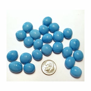May include: A collection of light blue glass pebbles, approximately the size of a US dime.