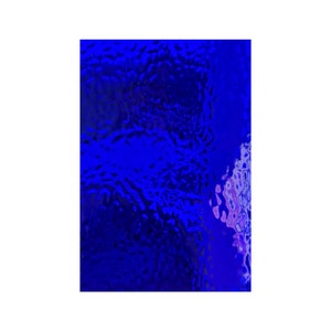 May include: A close-up of a blue textured glass surface with a slight purple hue in the upper right corner.