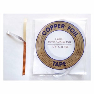 May include: A roll of 1/4 inch by 36 yard silver coated copper foil tape. The tape is packaged in a clear plastic bag with a gold and blue label that reads "COPPER FOIL TAPE" and "1 ROLL SILVER COATED FOIL 1/4" X 36 YDS MADE IN U.S.A."