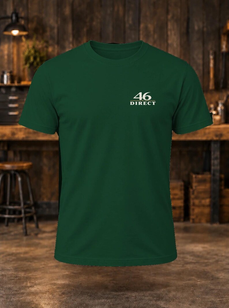 May include: A dark green short-sleeve t-shirt featuring a crew neckline. On the upper left chest, there is a white graphic print that displays the number 46 above the word DIRECT, with a horizontal line separating the two elements.