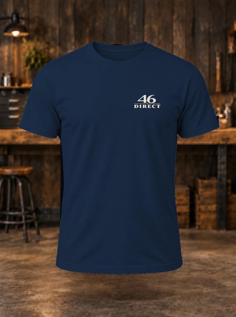 May include: A navy blue short-sleeve t-shirt featuring the white text 46 DIRECT printed on the upper left chest area. The shirt has a crew neckline and a standard fit, constructed from a solid-colored fabric with a clean, simple design.