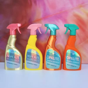 May include: Four plastic spray bottles with holographic labels. The first is gold with a pink nozzle and label reading NOPE-ALITE REVERSE OPALITE EXTREMELY TOXIC. The second is yellow with a pink nozzle and identical label. The third is orange with a teal nozzle and label reading OPALITE MAGICAL RESULTS! DON'T SWEAT IT. The fourth is orange with a teal nozzle and identical label.