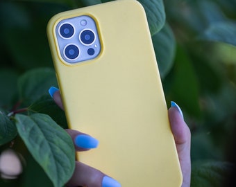 May include: A bright yellow phone case with a camera lens cutout. The case is made of silicone and has a smooth, matte finish.