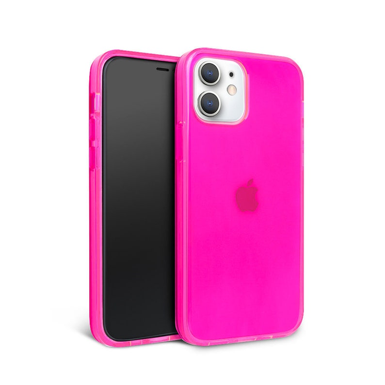 May include: A bright pink phone case with a clear back and a raised camera bump. The case is designed for an iPhone with a cutout for the Apple logo.