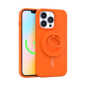May include: Orange phone case with a built-in ring holder. The case has a raised camera bump and a cutout for the phone's charging port.