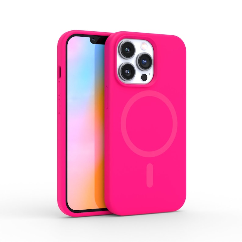 May include: A bright pink phone case with a matching phone. The case has a circular design on the back and a cutout for the camera. The phone screen is visible, and the case appears to be made of a smooth material.