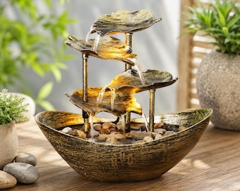 Fontana da tavolo moderna a forma di foglia di loto con cascata d'acqua per un arredamento zen.