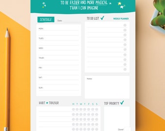 May include: A white weekly planner with a teal header that reads "I am willing for this to be easier and more magical than I can imagine." Includes sections for schedule, to-do list, habit tracker, and top priority. A pencil and a small succulent are also in the image.