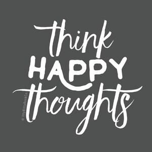 May include: White text on a dark gray background reads "think happy thoughts".