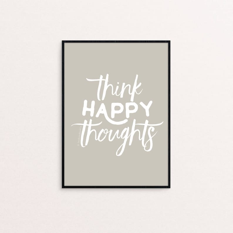 May include: A framed print with a light gray background and white text that reads "think happy thoughts".