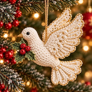 May include: A crocheted cream-colored dove ornament featuring gold-trimmed wings and tail feathers accented with small white pearls. The bird holds a sprig of green crocheted holly leaves with three red berries in its beak and hangs by a gold cord.