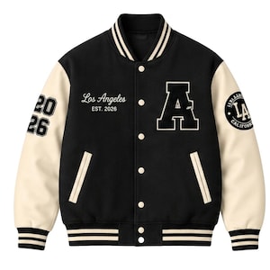 May include: A black varsity jacket with cream-colored sleeves, featuring a large letter A on the chest, the text Los Angeles EST. 2026, the number 2026 on the right sleeve, and a circular LA California patch on the left sleeve with striped trim.