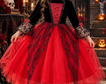 May include: A floor-length dress featuring a black velvet bodice with a red rose-patterned center panel, a high stand-up collar, and long sleeves with black lace cuffs. The skirt consists of layered red tulle with black lace overlays.