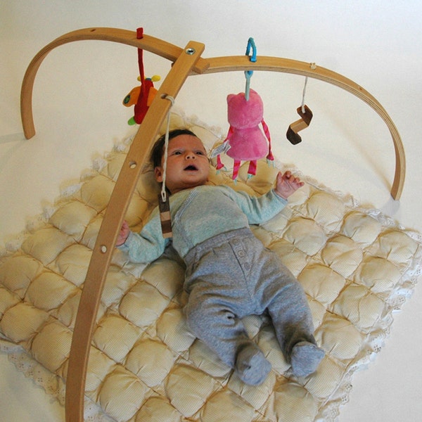 Wooden baby gym for hanging toys and mobiles. Natural wooden play gym. Folding modern activity center.