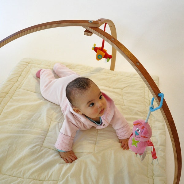 Mahogany veneer coated baby gym. Wooden baby gym for hanging toys and mobiles. Folding play gym.