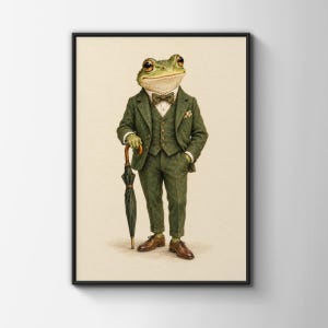 May include: A framed wall art print featuring an anthropomorphic frog dressed in a formal olive green three-piece suit, a white collared shirt, and a brown bow tie. The frog holds a closed dark green umbrella and wears brown leather dress shoes.