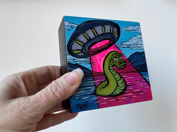 4x4” Lochness Monster Flying Saucer Cryptoid UAP UFO whimsical UV reactive painting by Tracy Levesque
