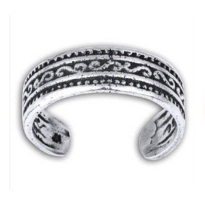 May include: Silver toe ring with an intricate, ornate design. The ring is made of metal and has a smooth, polished finish.
